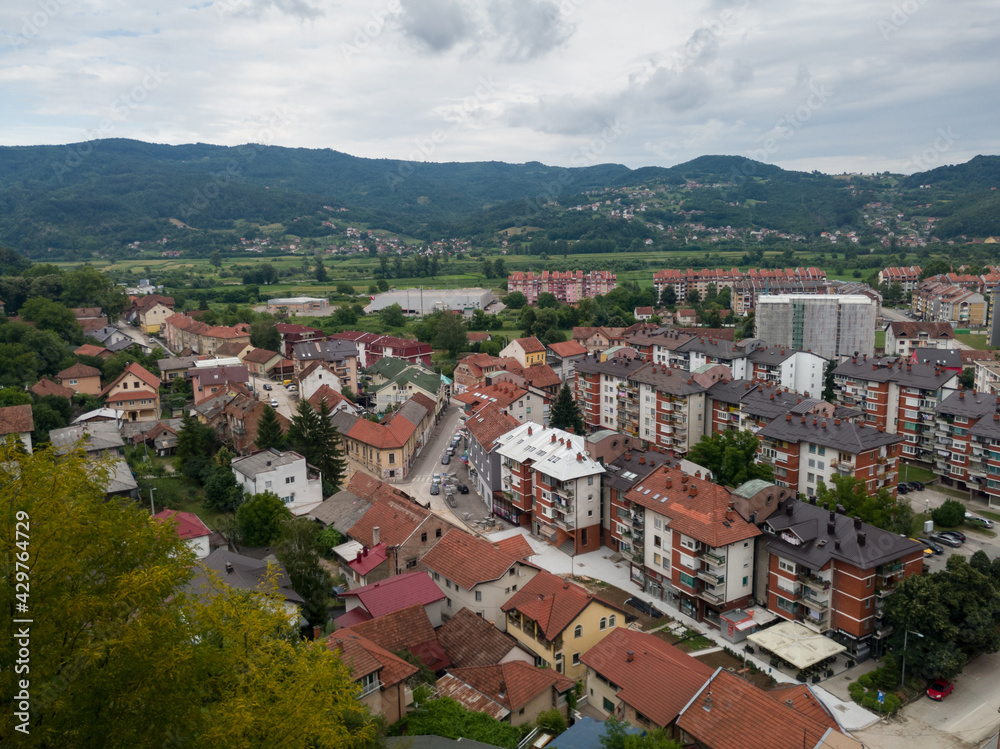 Aerial view of Doboj and hilly countryside from medieval fortress Gradina during overcast summer day.