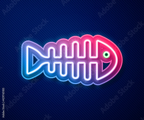 Glowing neon line Fish skeleton icon isolated on blue background. Fish bone sign. Vector
