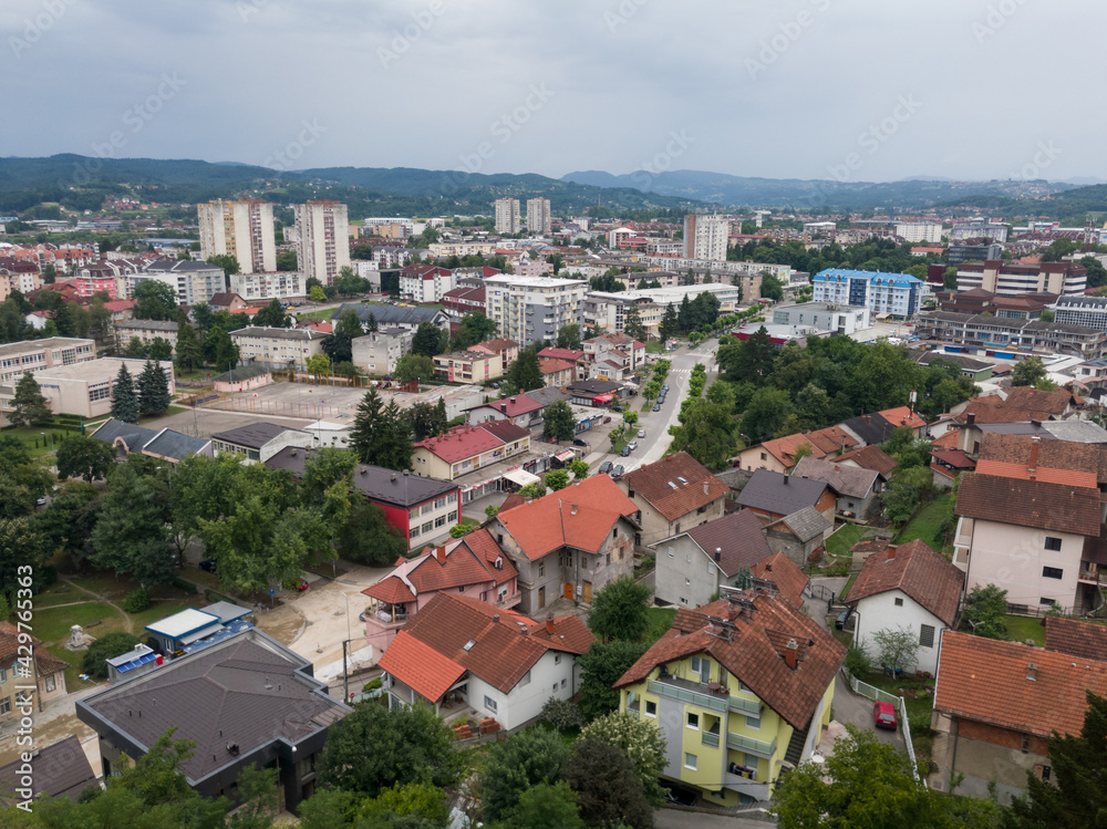 Aerial view of Doboj downtown from medieval fortress Gradina during overcast summer day.