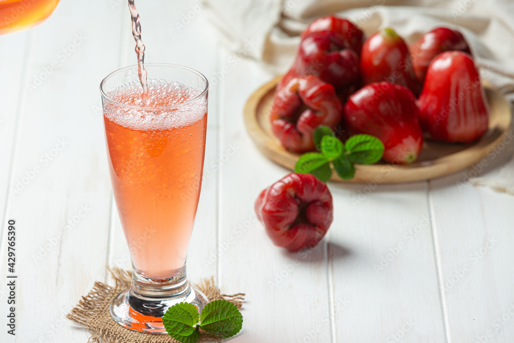 Rose apple juice on white wooden backgroud Rose apple juice on white wooden backgroud