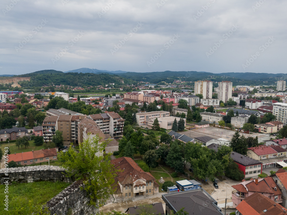 View of the town of Doboj and the hilly countryside from the Gradina fortress on the hill above the town during a cloudy summer day