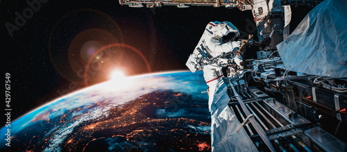 Print op canvas Astronaut spaceman do spacewalk while working for space station in outer space