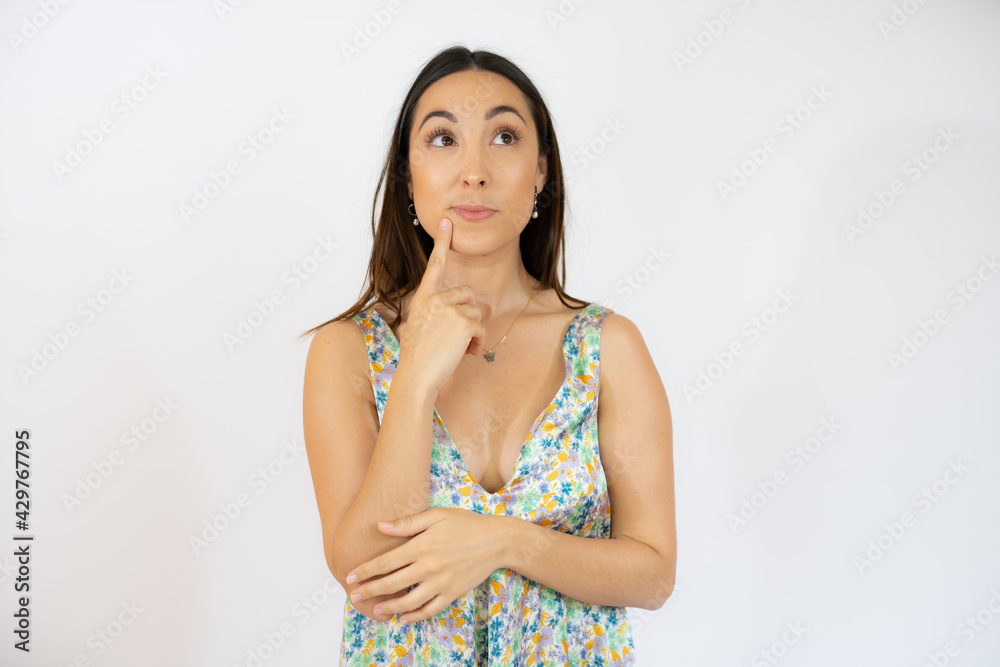 Portrait of a pensive beautiful young woman wearing casual clothes standing isolated over white background Portrait of a pensive beautiful young woman wearing casual clothes standing isolated over white background