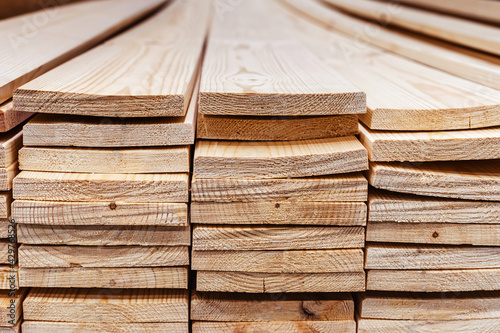 Pine boards in a warehouse of a building materials store. Wholesale and retail trade in processed wood. Close-up