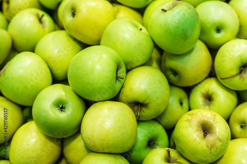 Green apples on the counter of a grocery store. Close-up