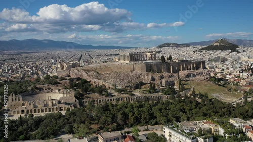 Aerial drone pan video of magnificent Acropolis hill and the Parthenon with great views to Plaka district and whole urban Athens, Attica, Greece photo