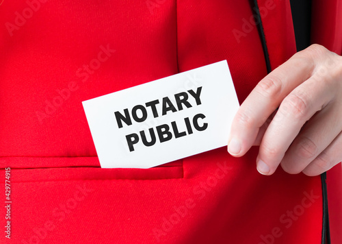 Notary Public inscription on the card in the hands of a businessman, puts the card in his jacket pocket