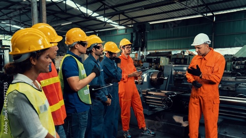 Obraz na płótnie Skillful worker attending brief meeting in the factory