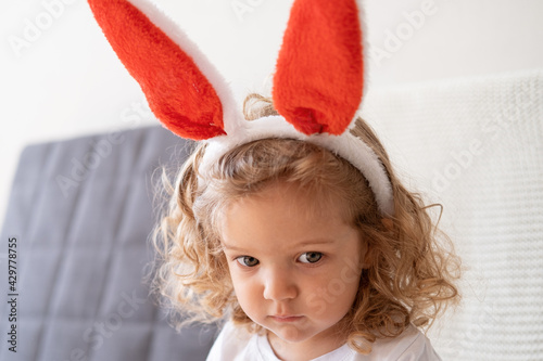 little sad cute girl in bunny ears. easter photo