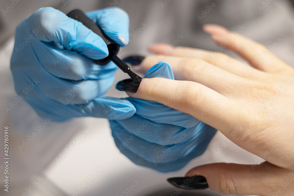 manicure in a beauty salon the process of nail polish coating manicure in a beauty salon the process of nail polish coating