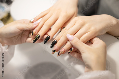 elegant female hands with long nails after procedure manicure in a beauty salon