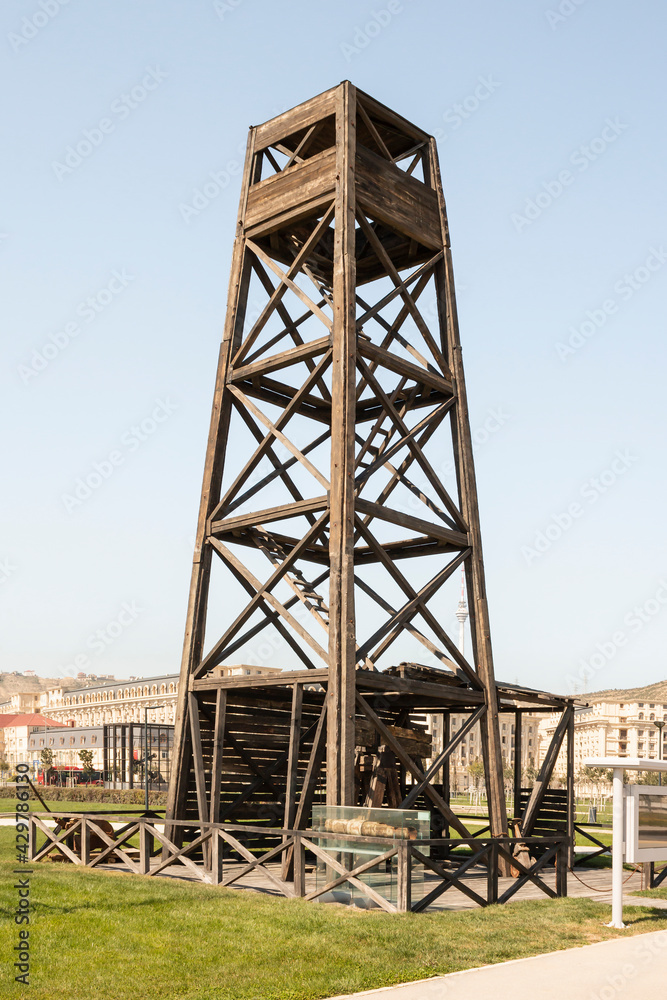 The method of oil production in the early 20th century. Wooden drilling rig. Flammable production. The method of oil production in the early 20th century. Wooden drilling rig. Flammable production.