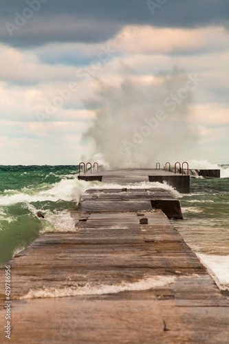 powerful crashing waves of lake Michigan overpowering a jetty © Nathaniel Gonzales