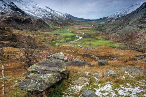  dramatic photo of the wintry autumn weather and snow capped mountains in the Nant Ffrancon Pass and Ogwen valley in Snowdonia National Park in North Wales.