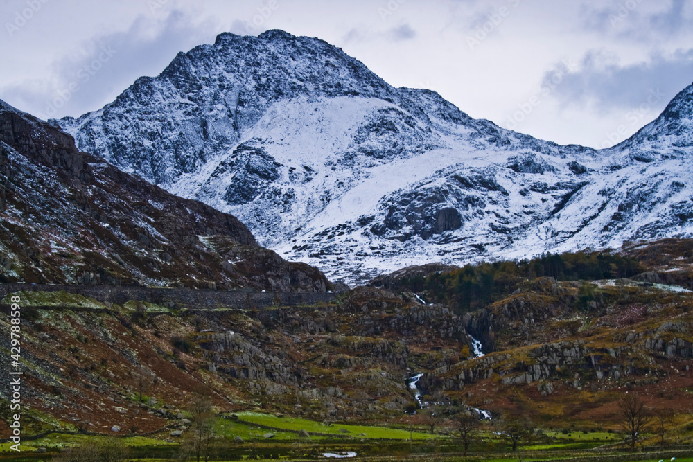 dramatic  photo of the wintry autumn weather and snow capped mountains in the Nant Ffrancon Pass and Ogwen valley in Snowdonia National Park in North Wales.