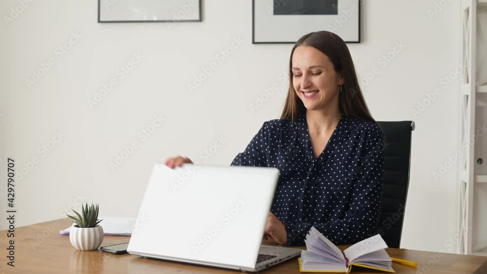 Smiling female manager finishing her works at the office, closing laptop computer looks aside dreamly, satisfied woman feels good and rests after productive day, happy with well done project Smiling female manager finishing her works at the office, closing laptop computer looks aside dreamly, satisfied woman feels good and rests after productive day, happy with well done project