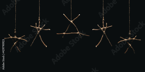 Witchcraft sticks symbols. Magic occult symbol. Many totems hanging on dark background. Mysticism and black magic concept. photo
