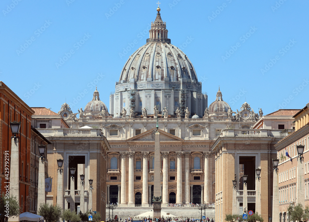 dome of St Peter s Basilica seen from the Via della Conciliazione with a large obelisk in the middle in Rome