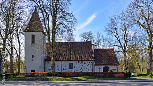 Fototapeta Naklejka Na Ścianę i Meble -  Currently erected in the 16th century, the Catholic Church of Saint Józef Rzemielnik in Nakomiady in Masuria, Poland. The photos show a general view of the temple.