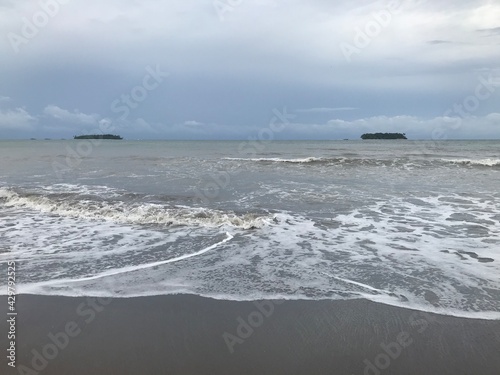 Stock Photo - foaming fading wave on sandy shoreline, wave cresting, foaming backwash, cresting waves down shoreline,