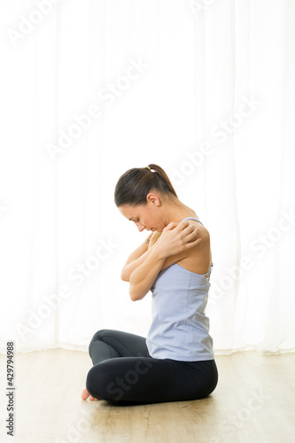 Portrait of gorgeous active sporty young woman practicing breathing exercises in yoga studio. Healthy active lifestyle, working out indoors in gym
