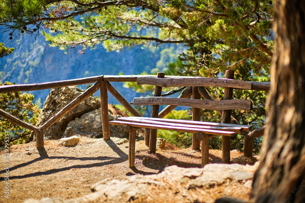 Wooden bench for resting uphill along a stone path.