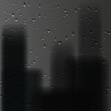 Rain drops on window glass with city background