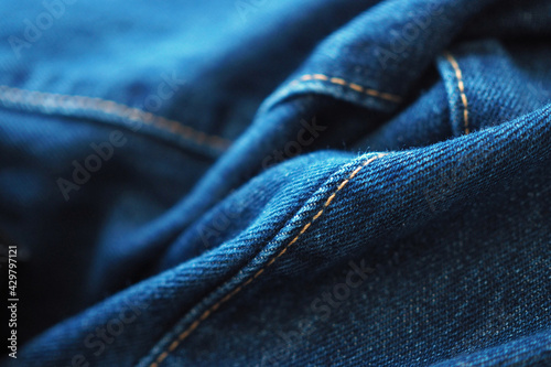 Close-up detail of seam on blue denim jeans 