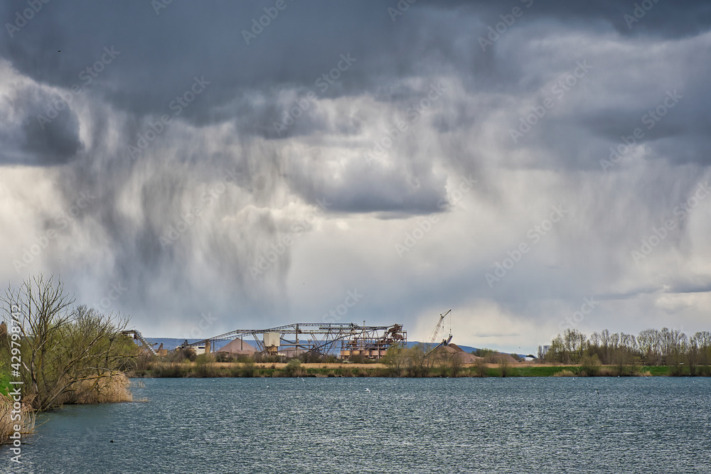 Naklejka premium rain clouds over a lake