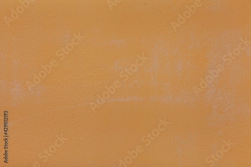 Cement walls painted in yellow-brown vintage texture and background seamless
