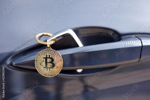 Bitcoin key hanging from a car door photo