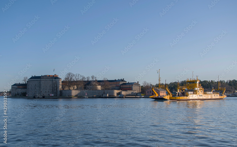 Morning water view at the harbor of Vaxholm a district of Stockholm with ferries and old fortress