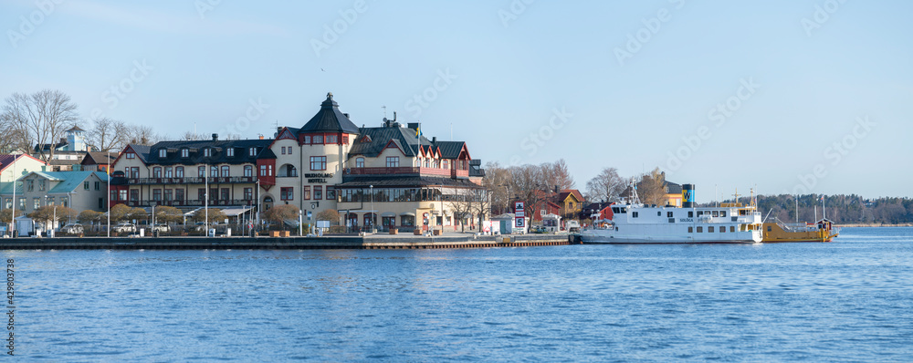 Morning water view at the harbor of Vaxholm a district of Stockholm with ferries and old houses