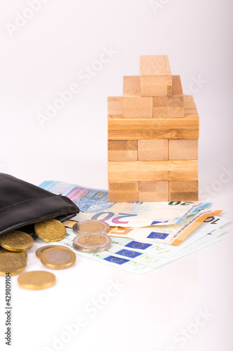 pile of paper and metal euro banknotes and coins on a white background as part of the united country's payment system