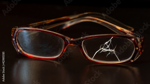 Broken glasses on a black background with reflection