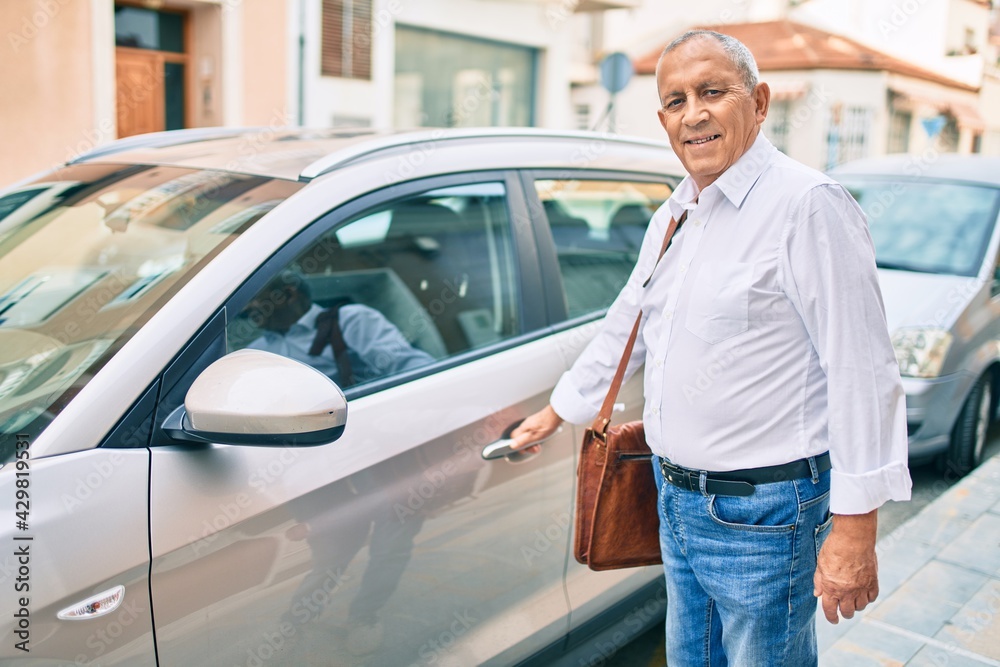 Senior man smiling happy opening car at the city. Senior man smiling happy opening car at the city.