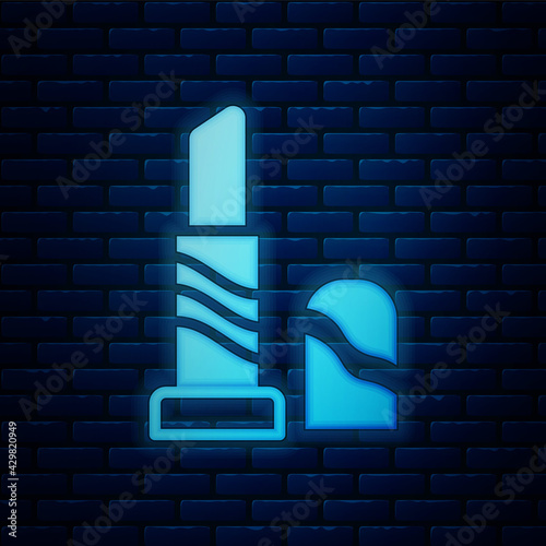 Glowing neon Lipstick icon isolated on brick wall background. 8 March. International Happy Women Day. Vector
