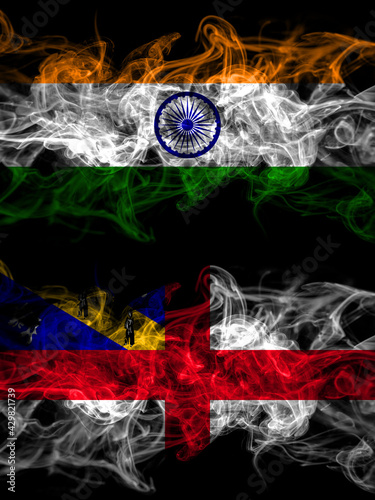 India  Indian vs United Kingdom  Great Britain  British  Herm  smoky mystic flags placed side by side. Thick colored silky abstract smoke flags.