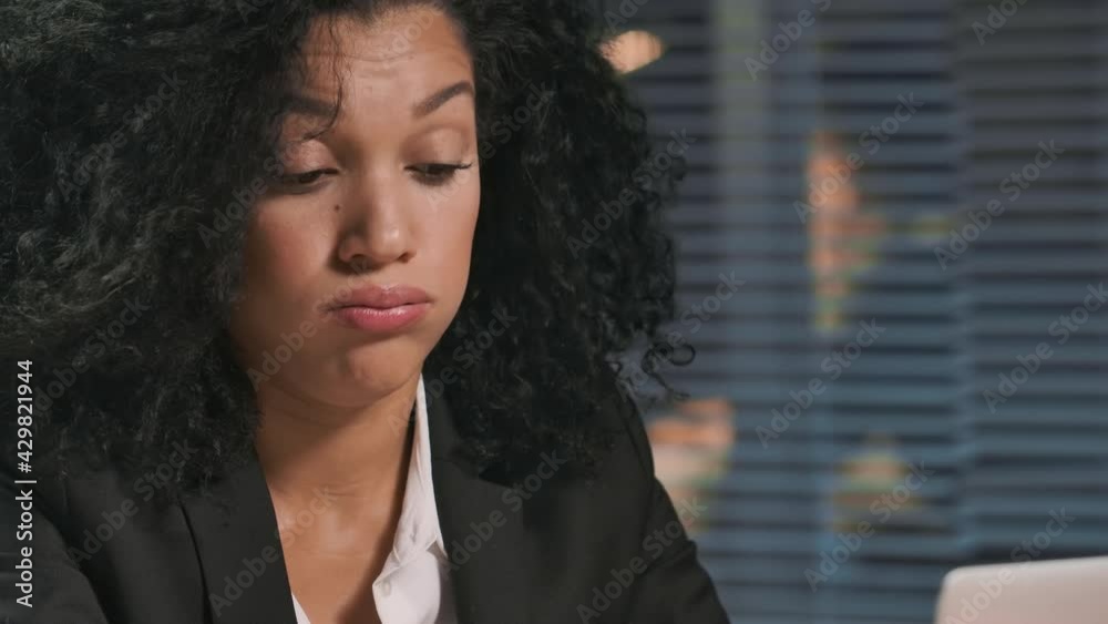 Portrait of African American woman in business suit, suffers from overwork and headache. Businesswoman posing at workplace, sitting at table in office. Close up. Slow motion ready, 4K at 59.94fps. Portrait of African American woman in business suit, suffers from overwork and headache. Businesswoman posing at workplace, sitting at table in office. Close up. Slow motion ready, 4K at 59.94fps.