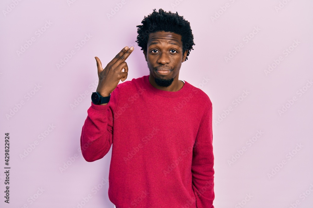 Young african american man wearing casual clothes shooting and killing oneself pointing hand and fingers to head like gun, suicide gesture.