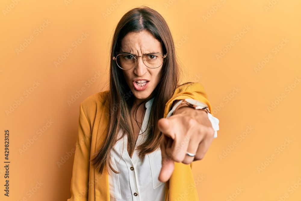 Young beautiful woman wearing business style and glasses pointing displeased and frustrated to the camera, angry and furious with you