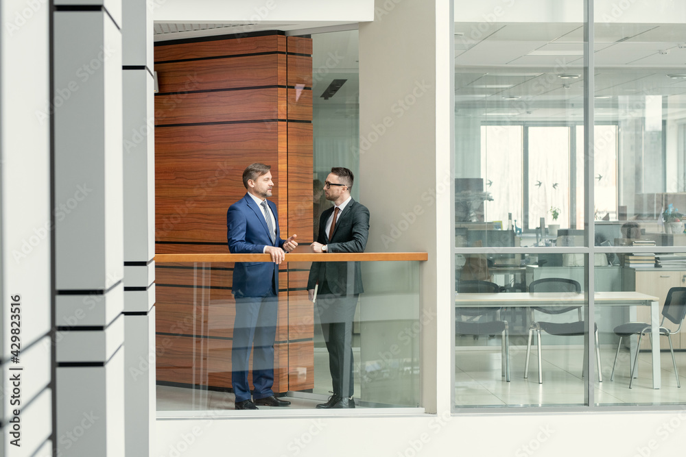 Businessmen talking in corridor