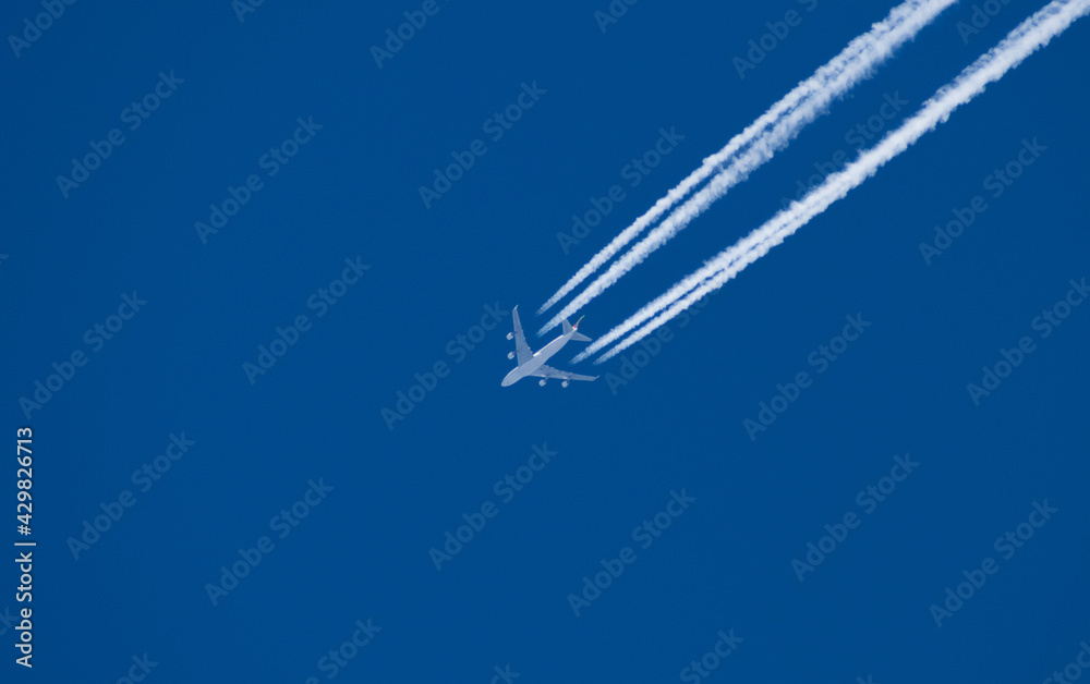 Passenger plane flying at high altitude. Blue sky. Travel, vacation - concept Passenger plane flying at high altitude. Blue sky. Travel, vacation - concept