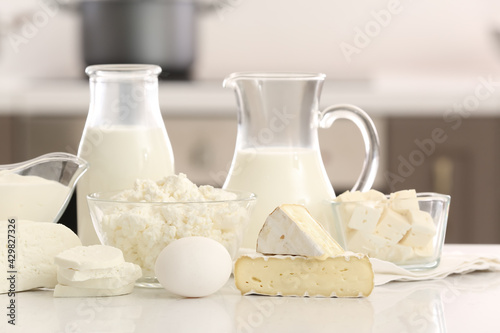 Different dairy products on table in kitchen