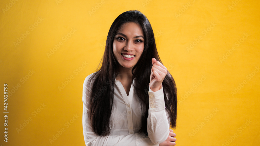 Self-confident satisfied young woman against neutral background - studio photography