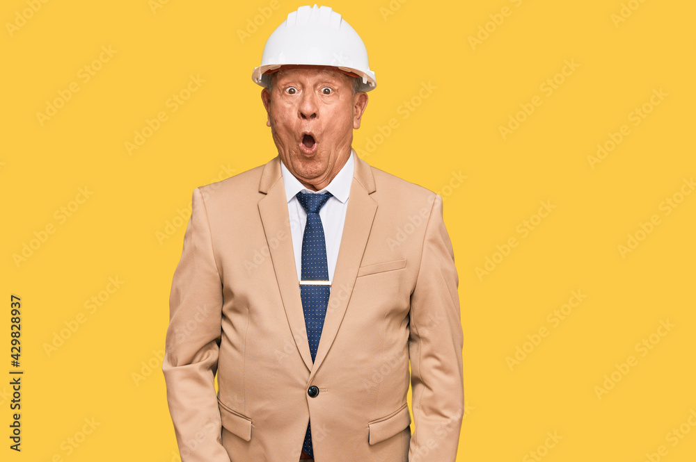 Senior caucasian man wearing architect hardhat scared and amazed with open mouth for surprise, disbelief face Senior caucasian man wearing architect hardhat scared and amazed with open mouth for surprise, disbelief face