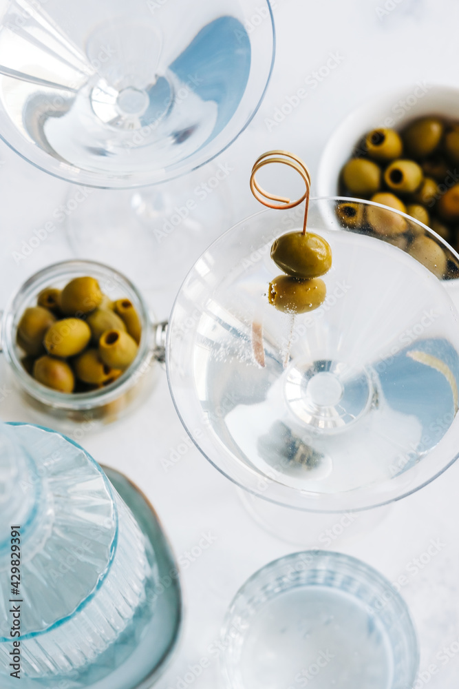 Martini cocktail in a glass on white background with olives. top view Martini cocktail in a glass on white background with olives. top view