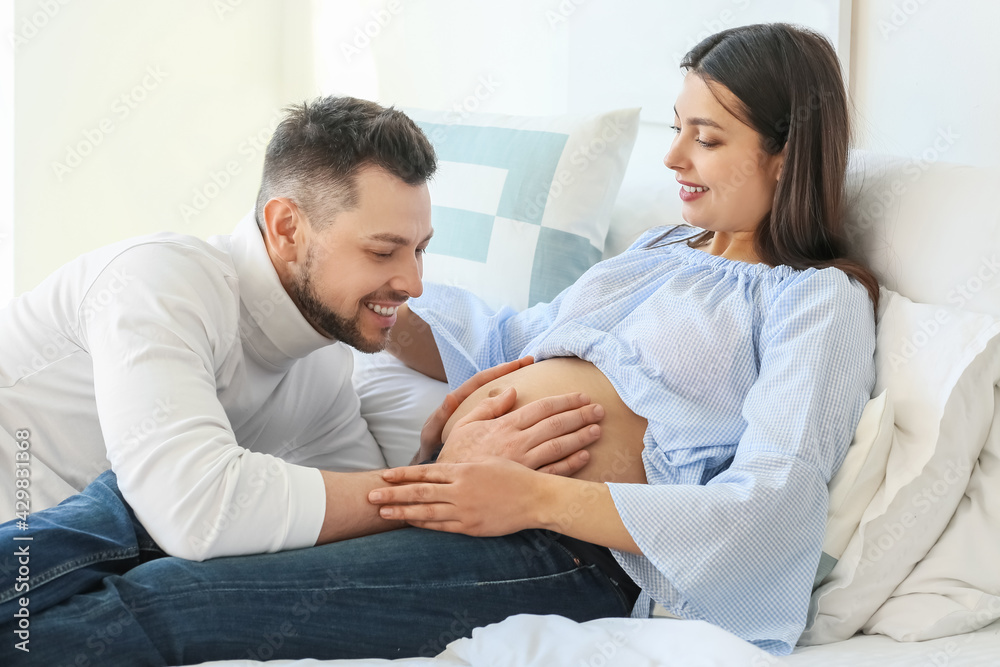 Fototapeta premium Beautiful pregnant couple at home