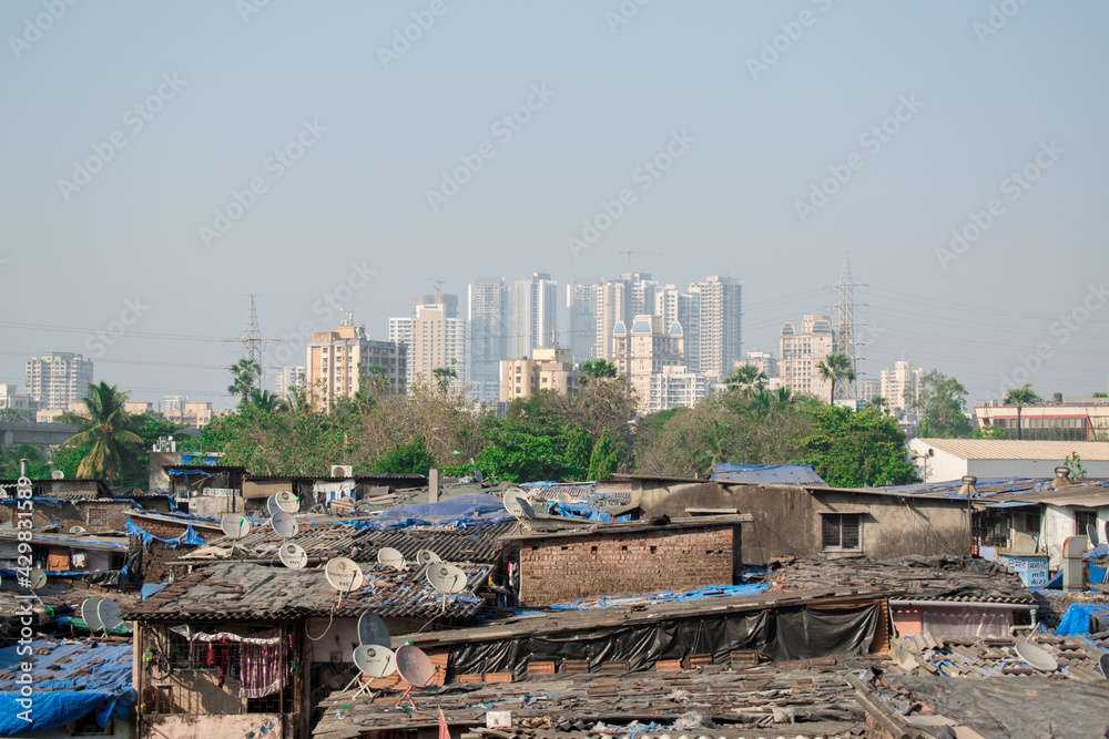 Rural to urban development of mumbai ,Maharashtra in one picture with trees and skyscrapers in background