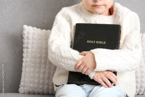 Little boy with Bible at home